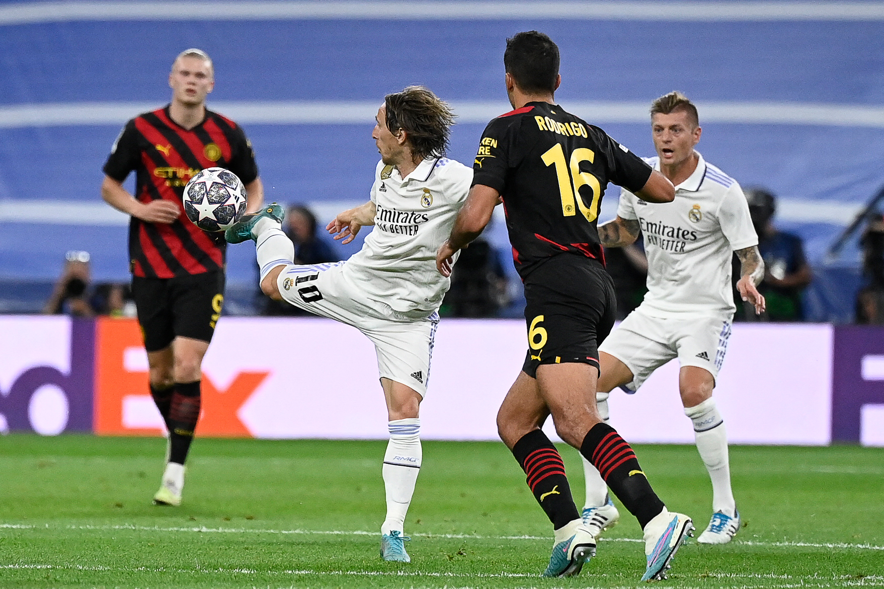 Real Madrid's Luka Modric, right, heads the ball past Manchester